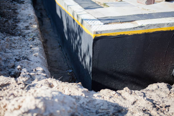 Professional Emergency Waterproofing technician working in Lennon, MI